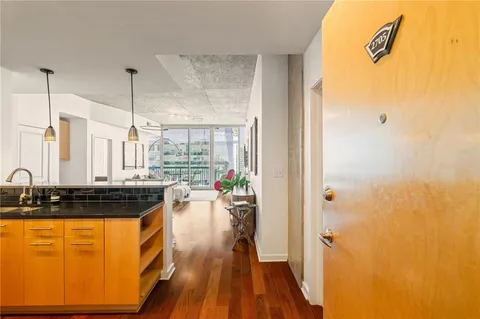 a kitchen with a sink a counter top space and stainless steel appliances