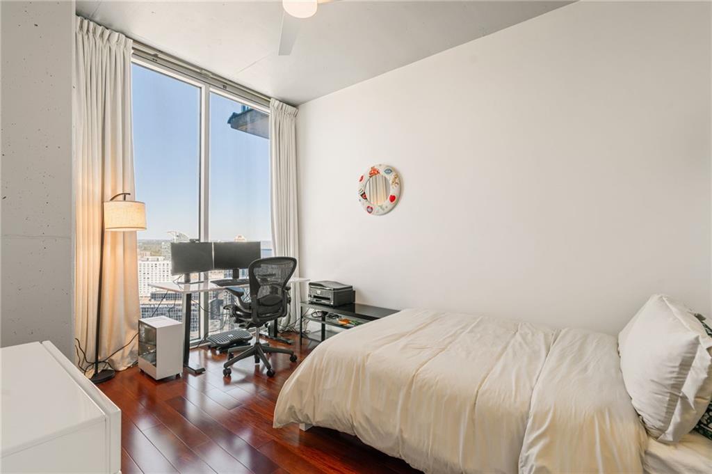 3324 Peachtree Road Northeast, Unit 2705 Atlanta, GA 30326 - Photo 31 of 68 a bedroom with a bed and a table in it