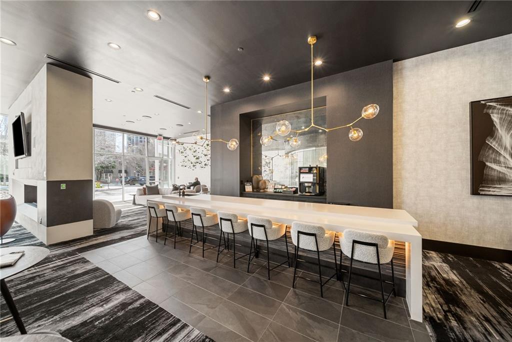 3324 Peachtree Road Northeast, Unit 2705 Atlanta, GA 30326 - Photo 47 of 68 a large dining hall with stainless steel appliances granite countertop a stove a sink a dining table and chairs with wooden floor