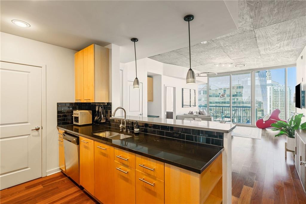 3324 Peachtree Road Northeast, Unit 2705 Atlanta, GA 30326 - Photo 6 of 68 a kitchen with a sink a counter top space and stainless steel appliances