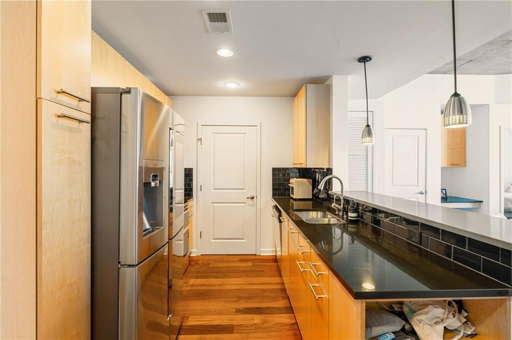 3324 Peachtree Road Northeast, Unit 2705 Atlanta, GA 30326 - Photo 7 of 68 a kitchen with stainless steel appliances a sink stove and refrigerator