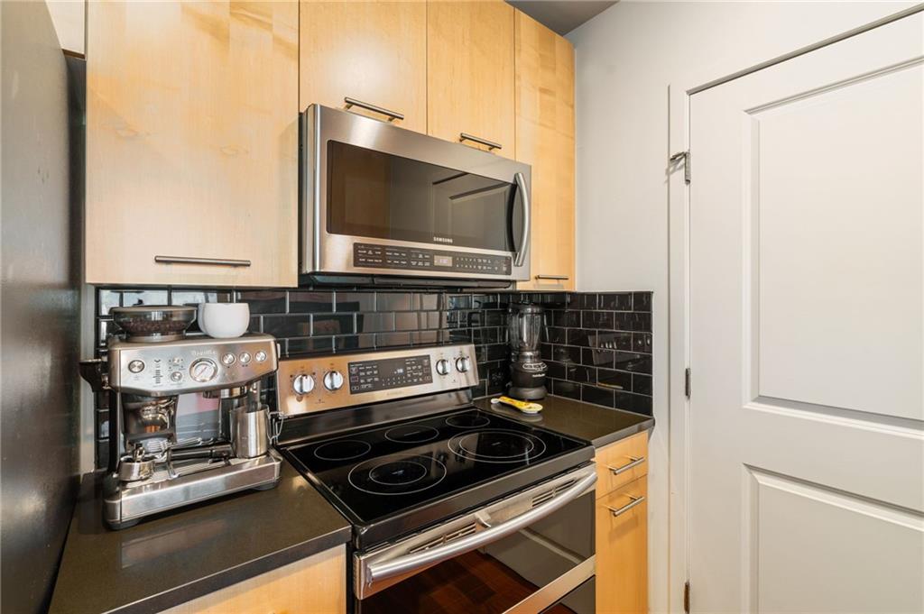 3324 Peachtree Road Northeast, Unit 2705 Atlanta, GA 30326 - Photo 8 of 68 a kitchen with a stove and a microwave