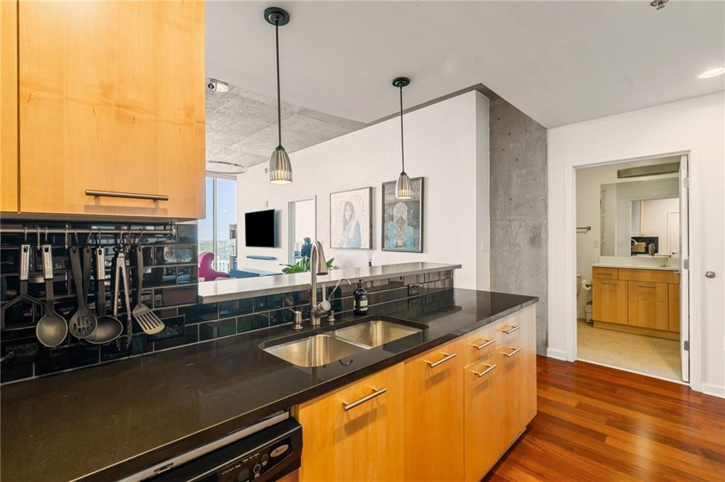 3324 Peachtree Road Northeast, Unit 2705 Atlanta, GA 30326 - Photo 10 of 68 a kitchen with stainless steel appliances granite countertop a sink a stove and a wooden cabinets