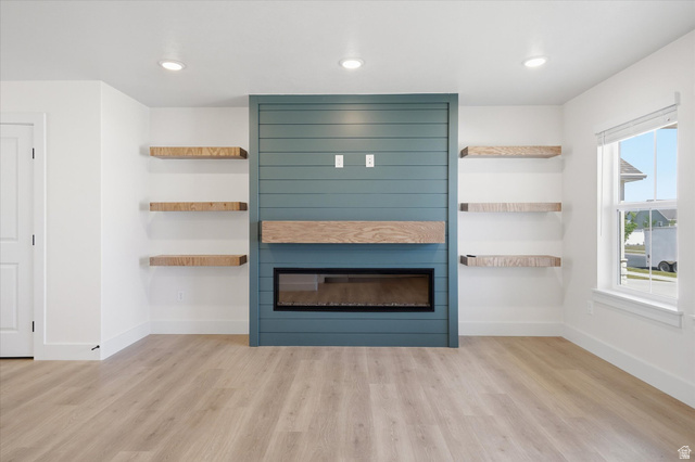 730 West 500 North Smithfield, UT 84335 - Photo 6 of 46 Accent wall featuring teal shiplap paneling and a linear electric fireplace
