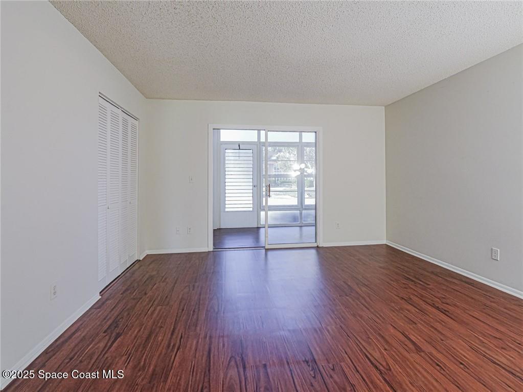25 Pine Arbor Lane, Unit 104 Vero Beach, FL 32962 - Photo 11 of 34 a view of an empty room with wooden floor and a window