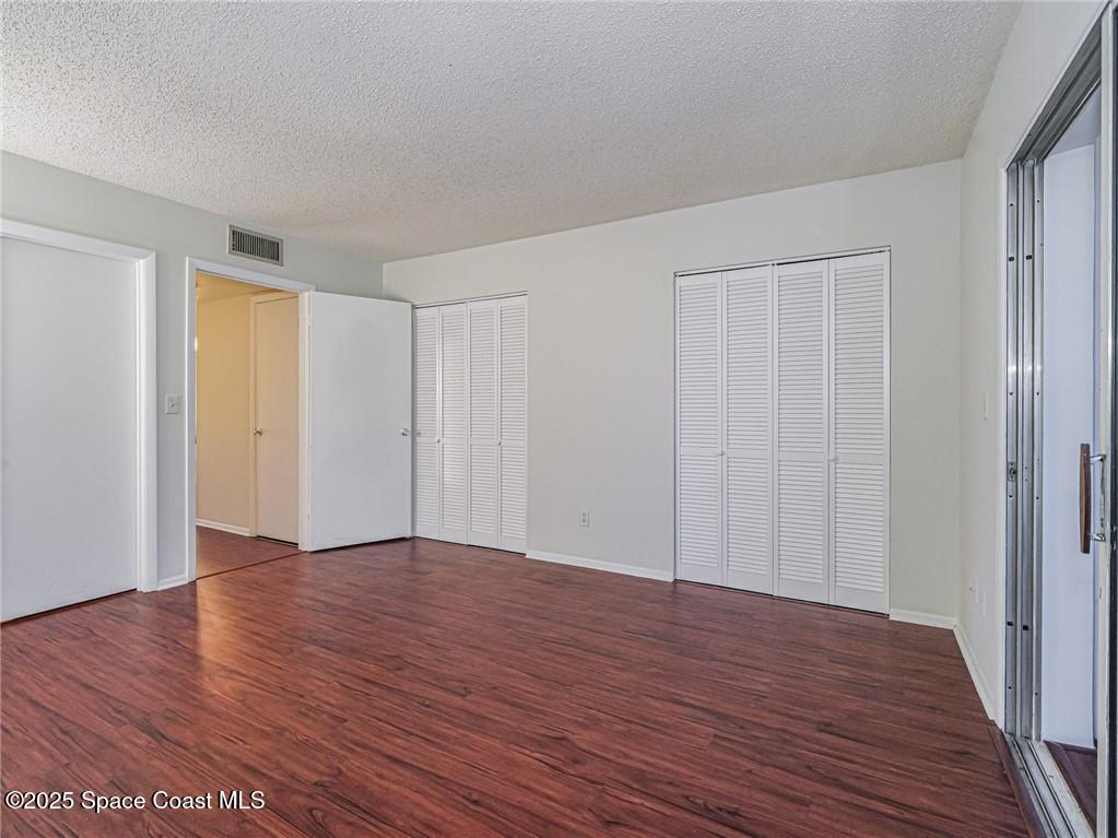 25 Pine Arbor Lane, Unit 104 Vero Beach, FL 32962 - Photo 12 of 34 a view of an empty room with wooden floor