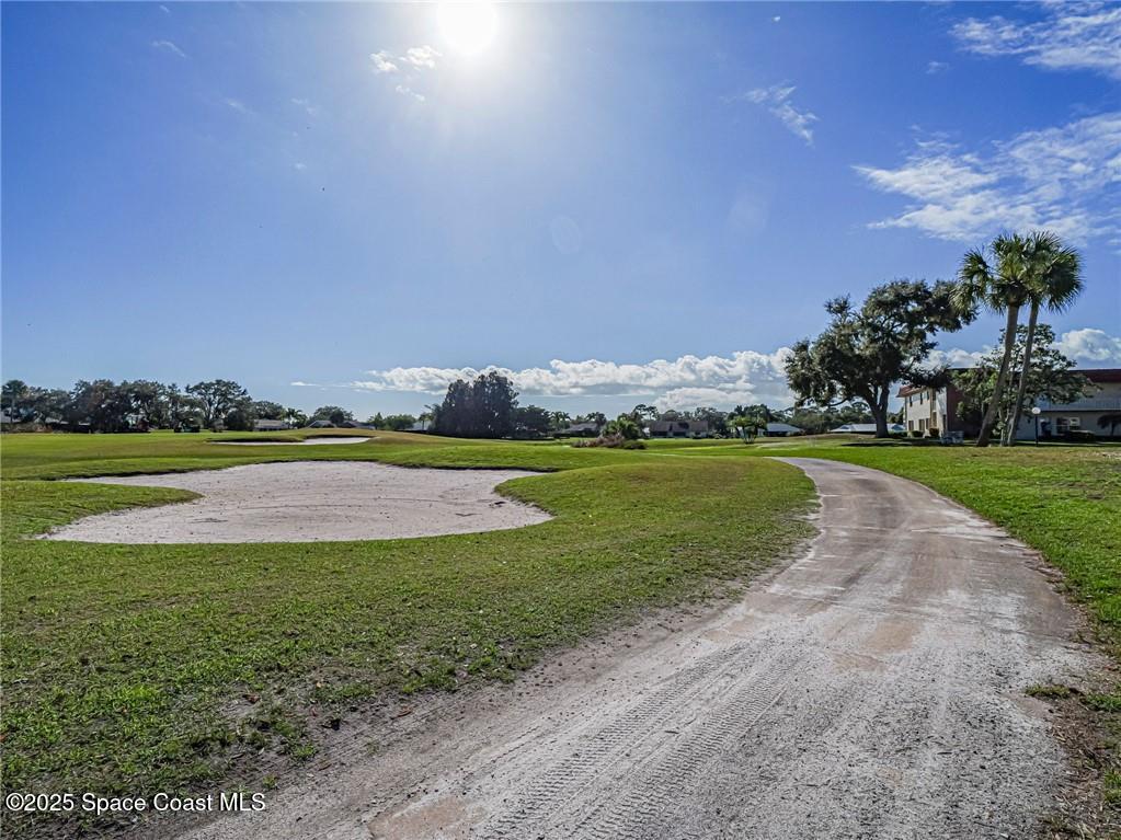 25 Pine Arbor Lane, Unit 104 Vero Beach, FL 32962 - Photo 24 of 34 a view of a lake with houses in the background