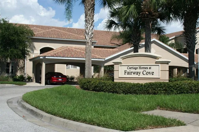 a view of a house with a yard and potted plants