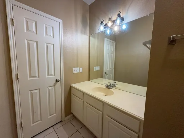 a bathroom with a sink vanity and a mirror