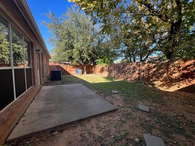 a view of a backyard with large trees