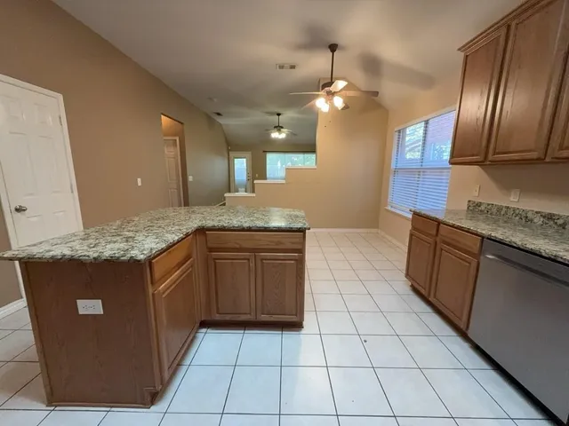 a kitchen with a sink a counter top space cabinets and stainless steel appliances