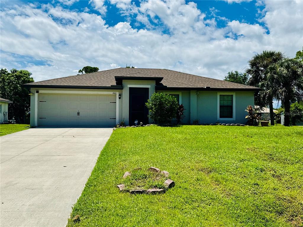 a front view of a house with a garden and pathway
