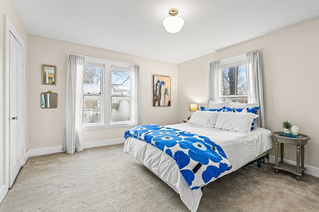 7 Water Street Natick, MA 01760 - Photo 17 of 26 a bedroom with a bed and glass window