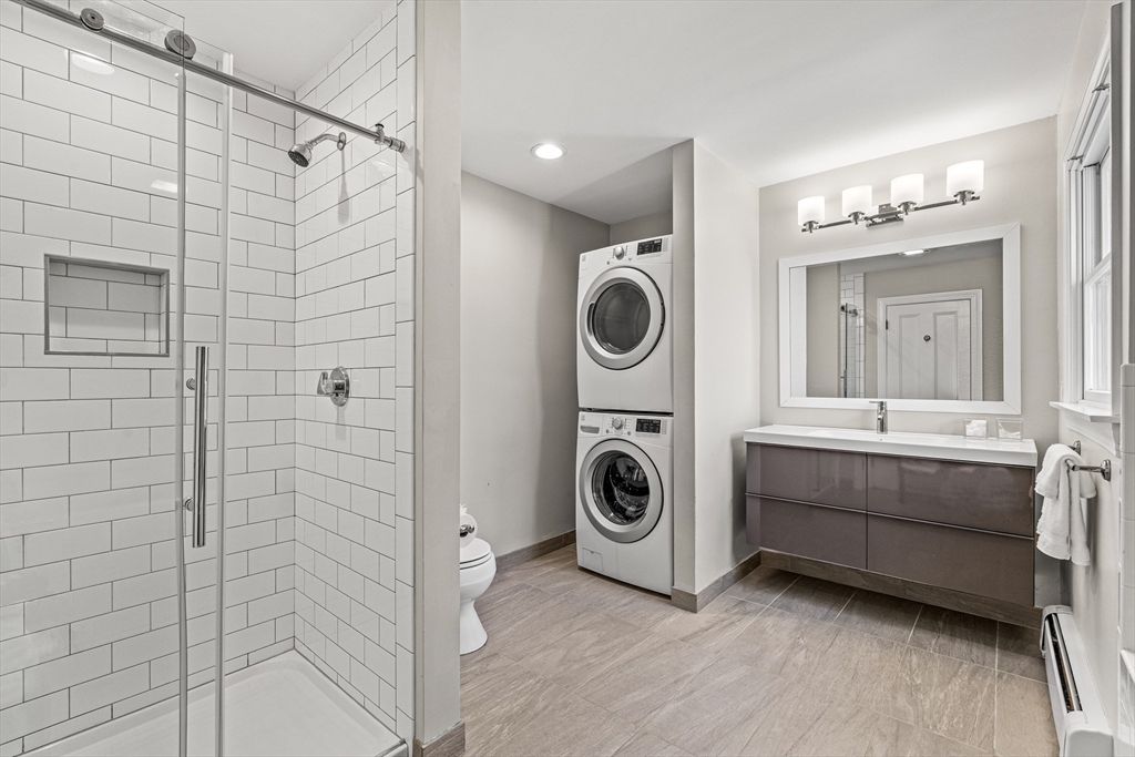 7 Water Street Natick, MA 01760 - Photo 19 of 26 a bathroom with a sink a washer and dryer