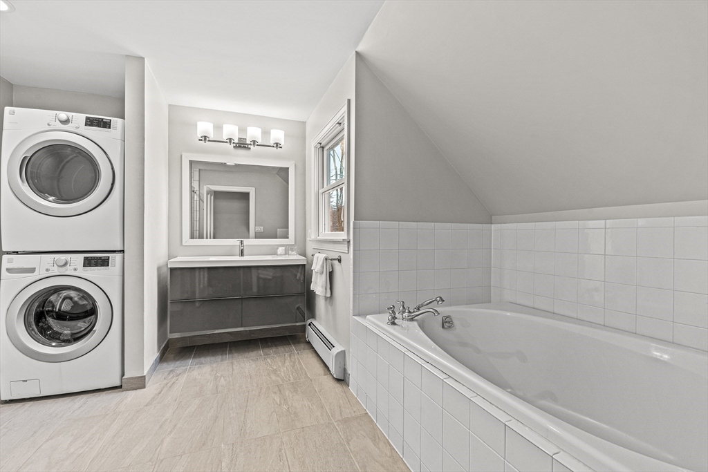 7 Water Street Natick, MA 01760 - Photo 20 of 26 a bathroom with a bathtub sink and mirror