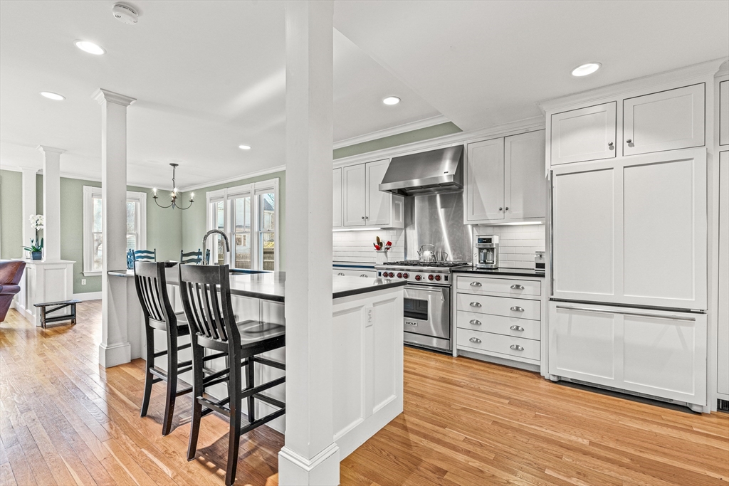 7 Water Street Natick, MA 01760 - Photo 4 of 26 a kitchen with white cabinets and stainless steel appliances
