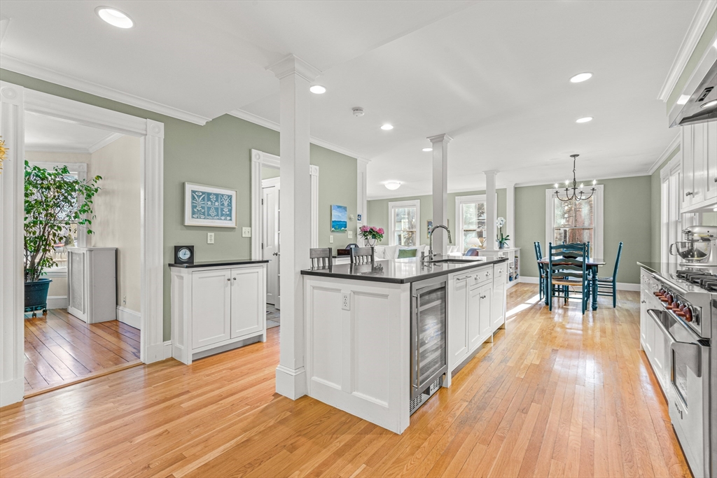 7 Water Street Natick, MA 01760 - Photo 5 of 26 a kitchen with white cabinets and wooden floor