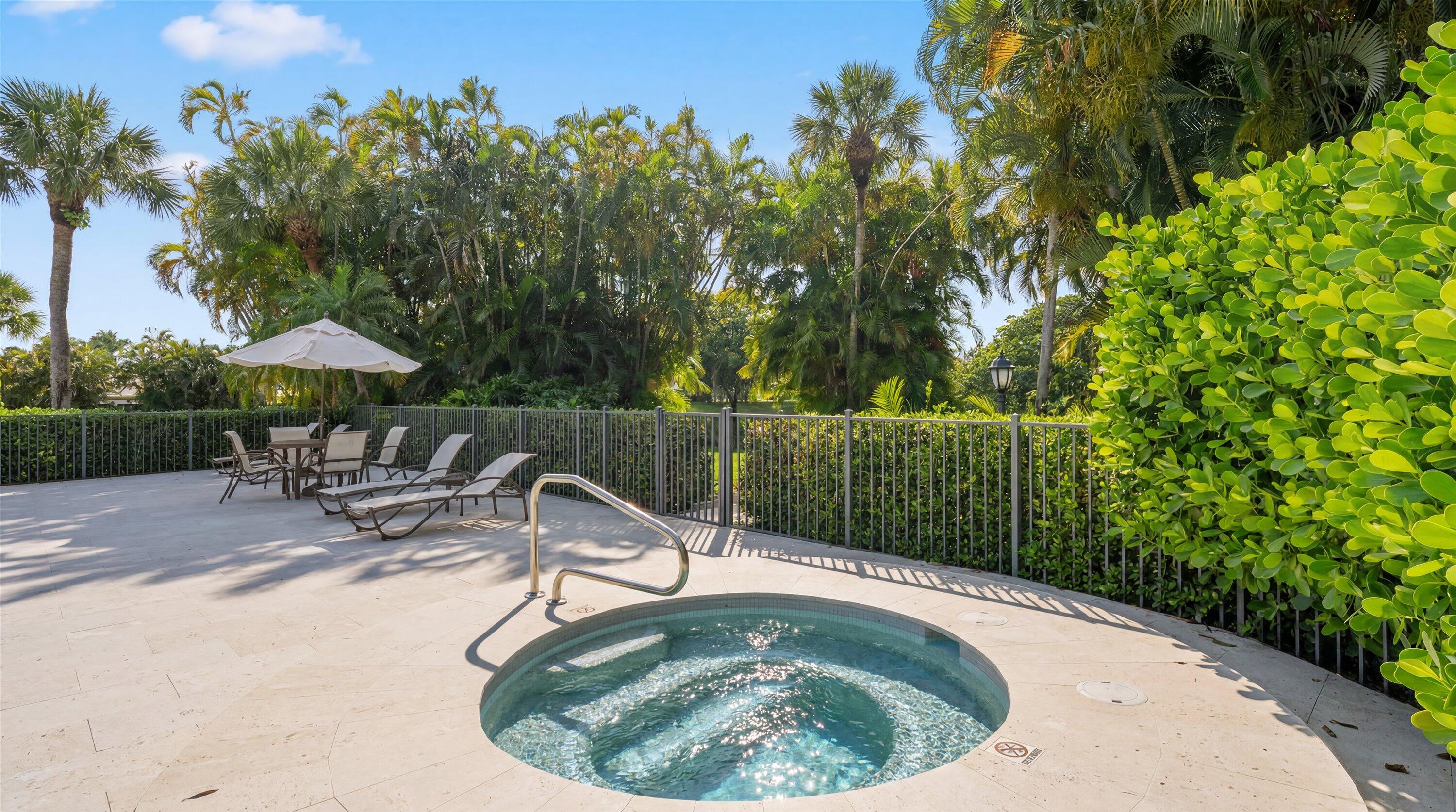 13400 Polo Road West, Unit 203 Wellington, FL 33414 - Photo 25 of 26 a view of a swimming pool with a patio and a garden