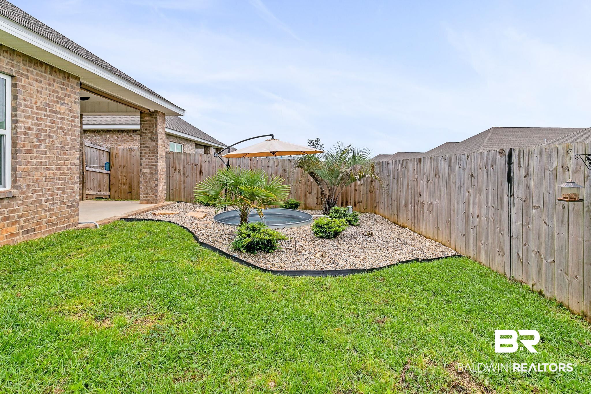 31650 Memphis Loop Daphne, AL 36527 - Photo 44 of 68 Fenced backyard with a patio