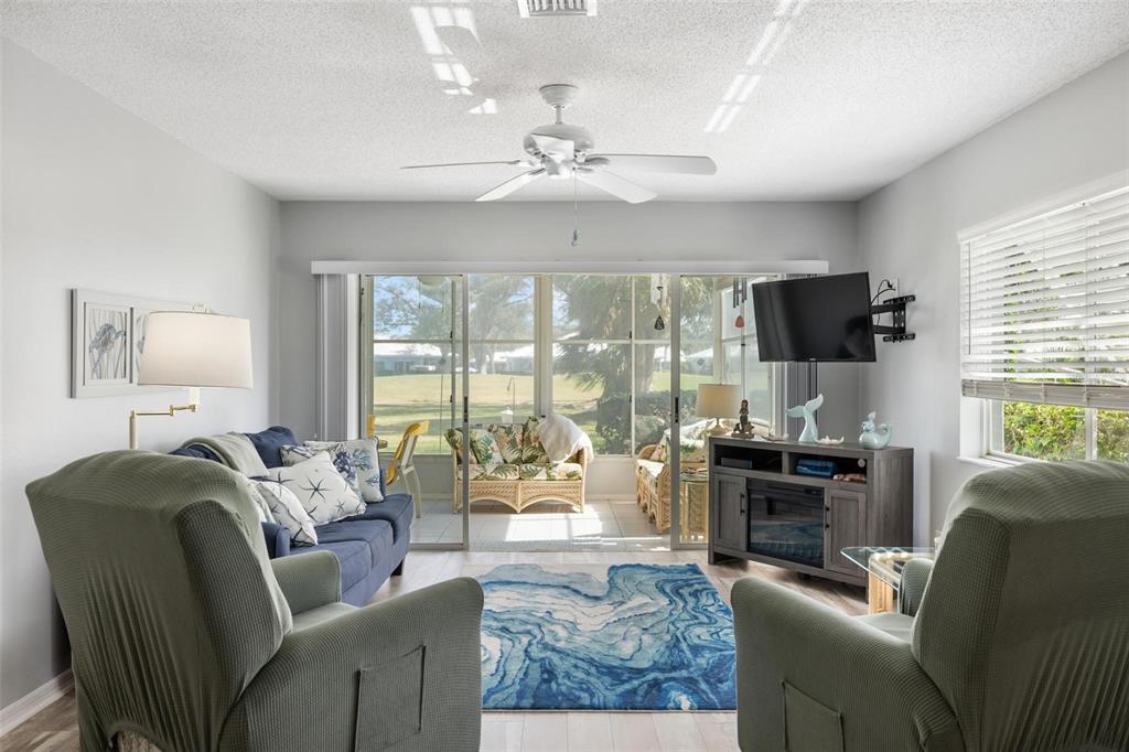 276 Cerromar Way South, Unit 60 Venice, FL 34293 - Photo 11 of 31 a living room with fireplace furniture and a flat screen tv
