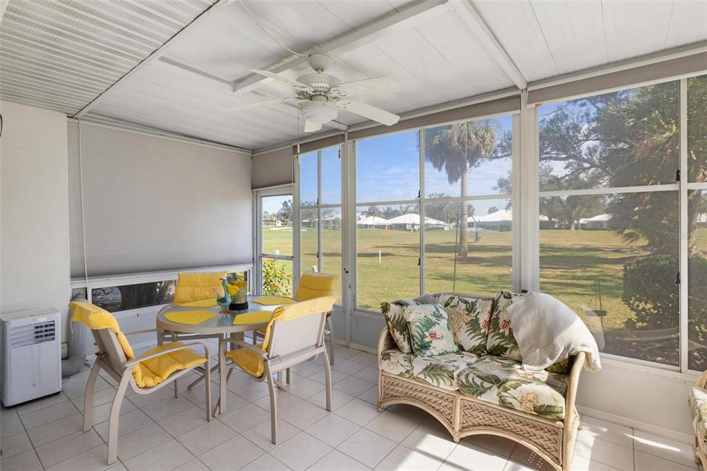 276 Cerromar Way South, Unit 60 Venice, FL 34293 - Photo 14 of 31 a living room with furniture and floor to ceiling windows