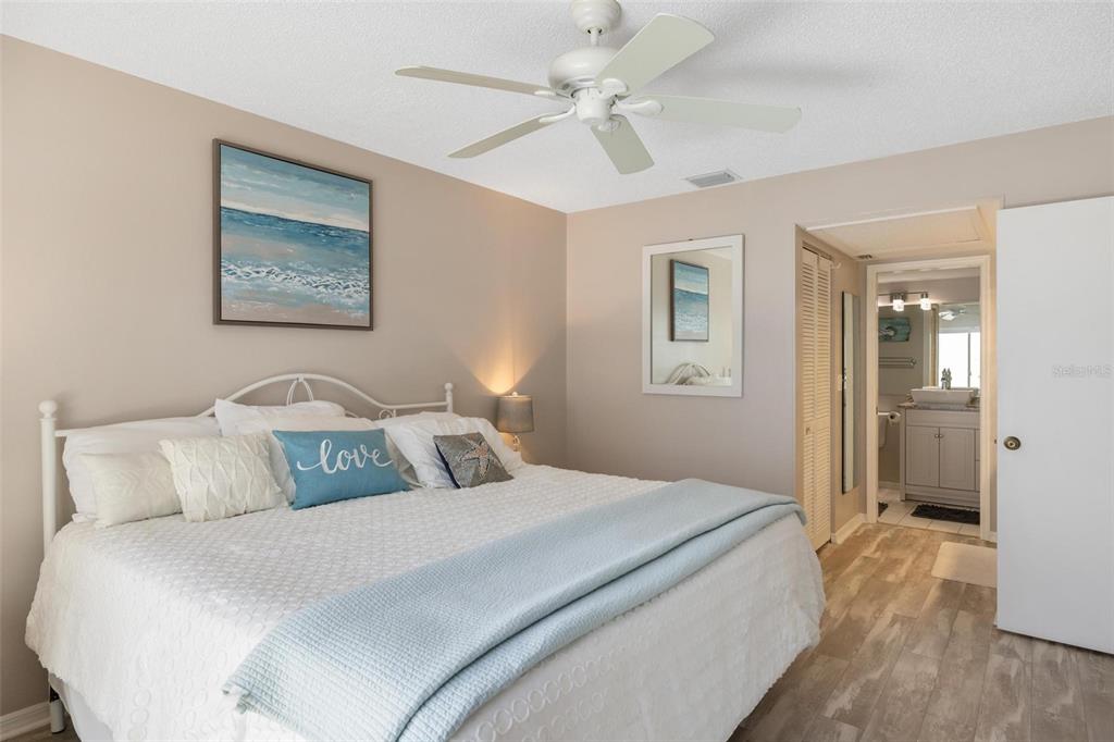 276 Cerromar Way South, Unit 60 Venice, FL 34293 - Photo 18 of 31 a bedroom with a large bed and a ceiling fan