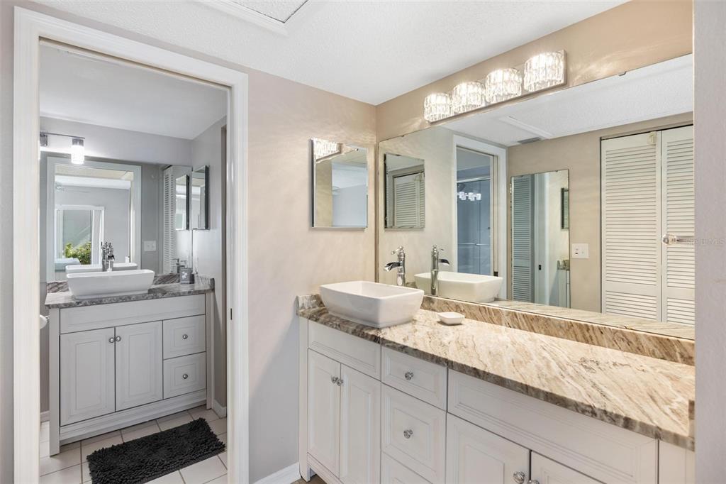 276 Cerromar Way South, Unit 60 Venice, FL 34293 - Photo 19 of 31 a bathroom with a granite countertop sink mirror and double