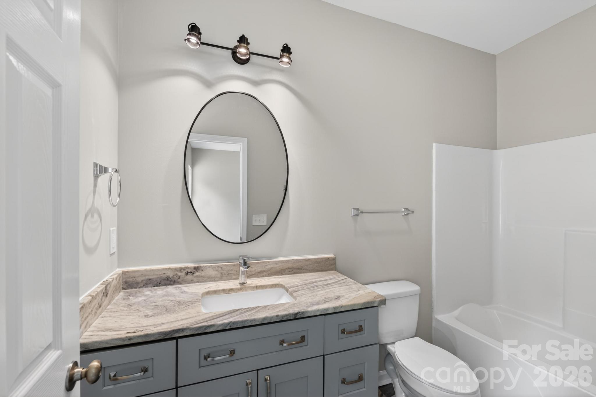 2119 South Road Morganton, NC 28655 - Photo 30 of 47 a bathroom with a granite countertop toilet sink and mirror