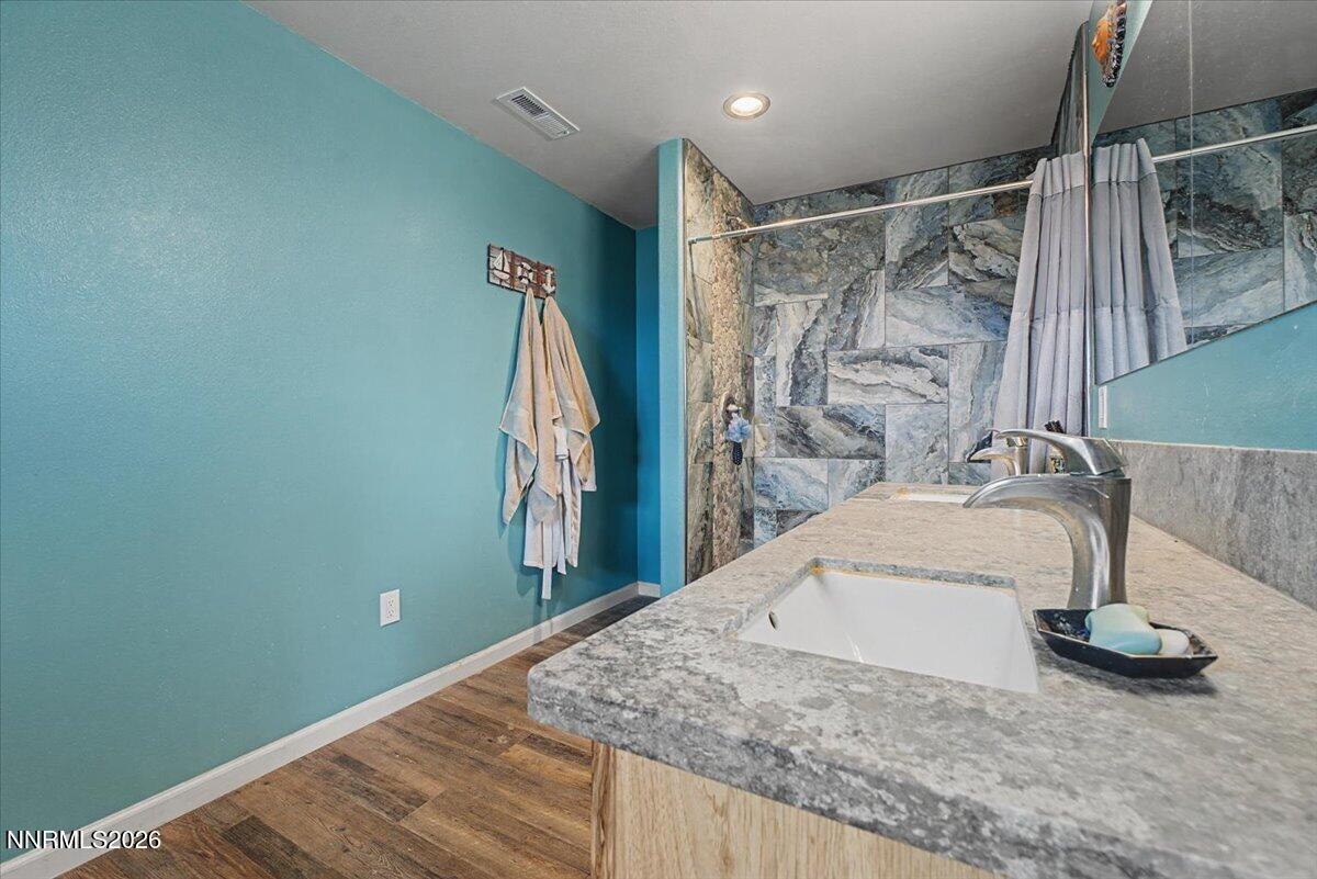 2300 Temple Hill Road Reno, NV 89521 - Photo 15 of 63 a bathroom with a granite countertop sink and a mirror