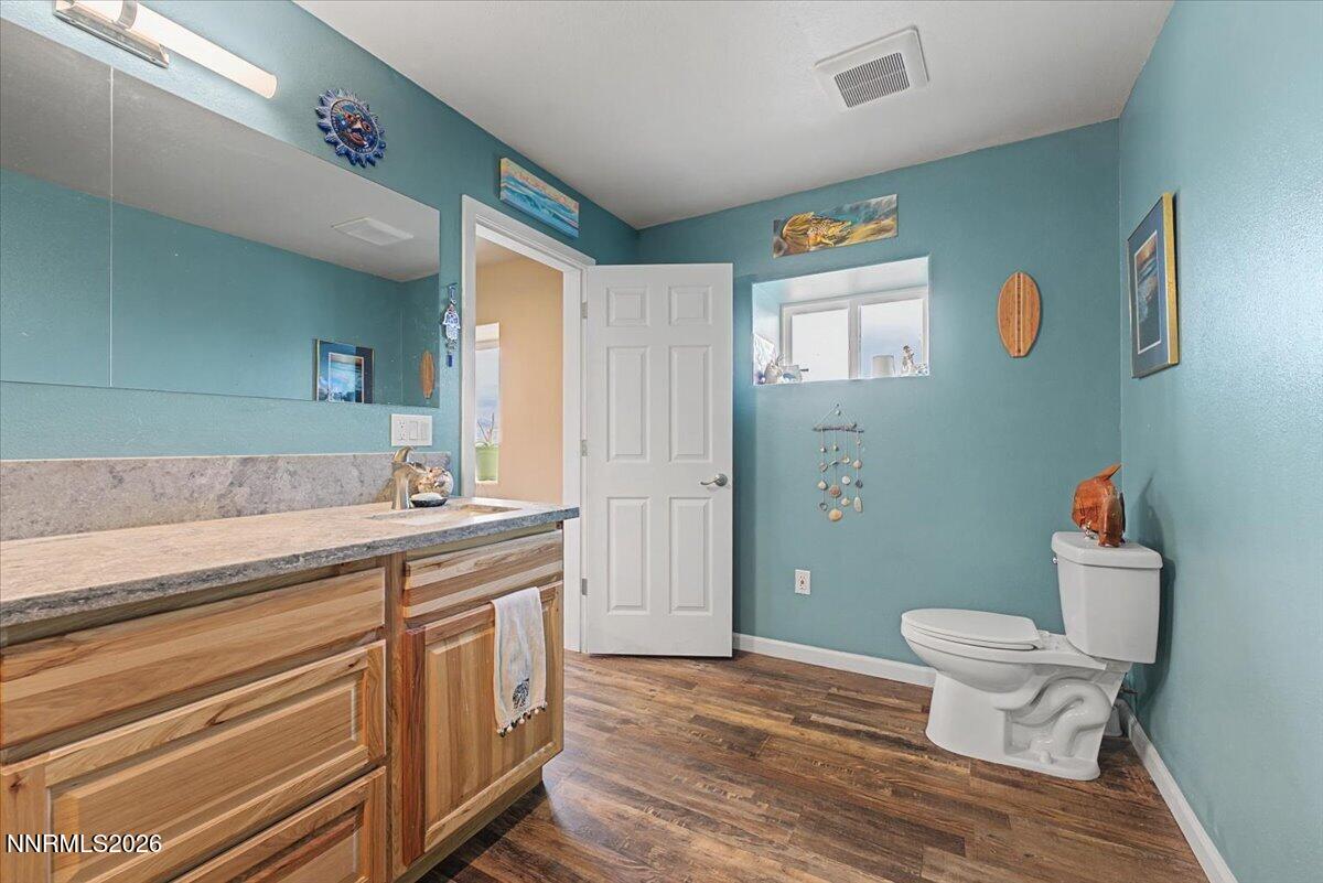 2300 Temple Hill Road Reno, NV 89521 - Photo 19 of 63 a bathroom with a granite countertop toilet a sink and a mirror