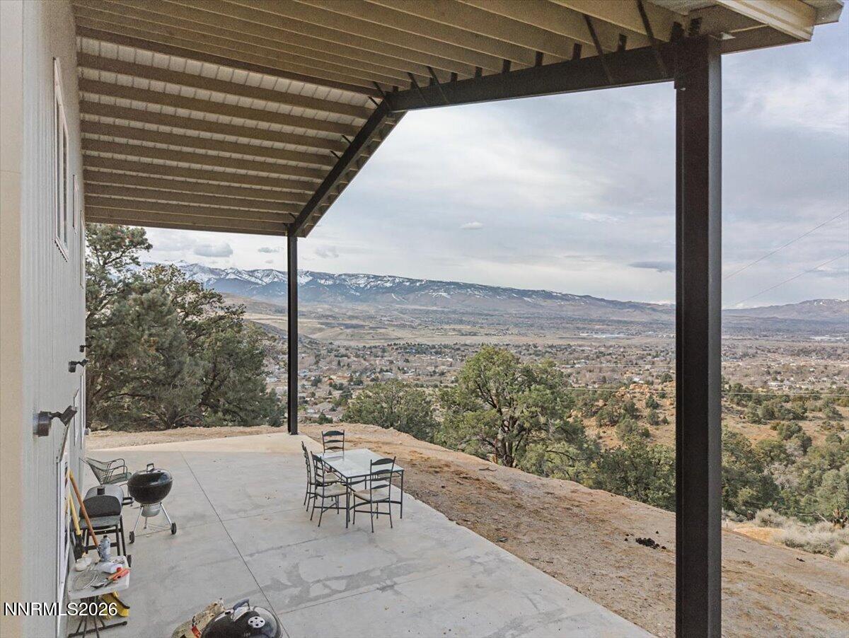 2300 Temple Hill Road Reno, NV 89521 - Photo 36 of 63 a view of a patio with a table chairs and wooden fence