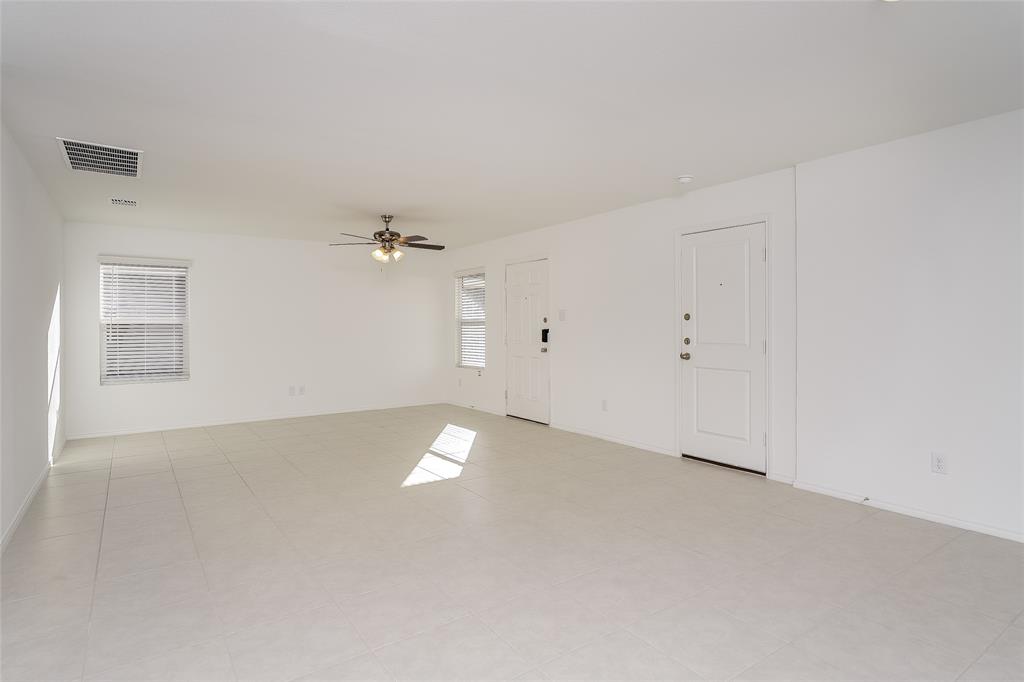 5641 Rockrose Lane Princeton, TX 75407 - Photo 15 of 16 an empty room with a ceiling fan and a window