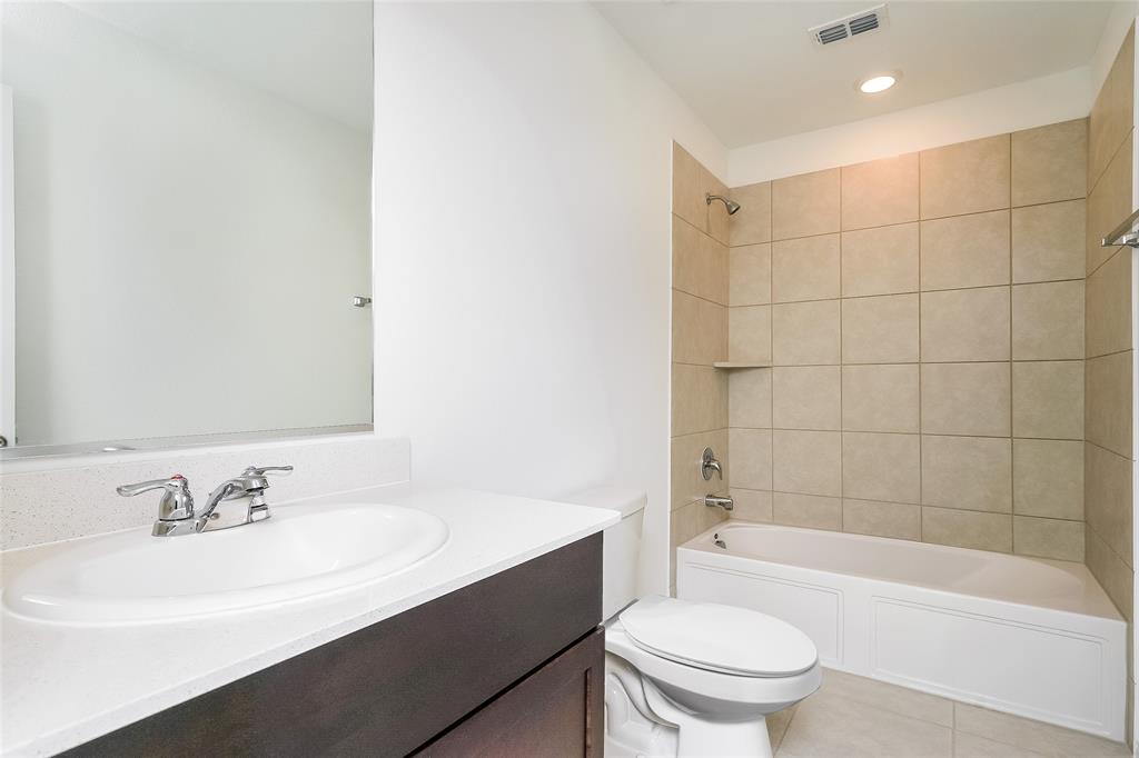 5641 Rockrose Lane Princeton, TX 75407 - Photo 2 of 16 a bathroom with a sink a toilet and bathtub