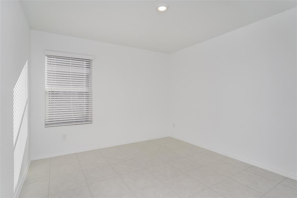 5641 Rockrose Lane Princeton, TX 75407 - Photo 4 of 16 an empty room with a window