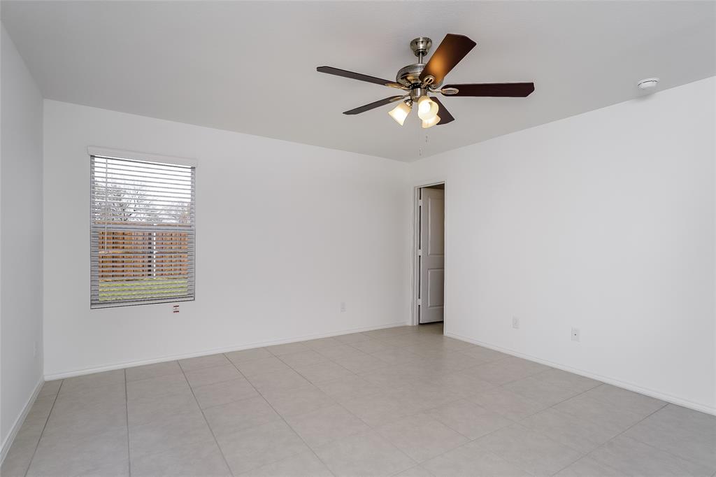 5641 Rockrose Lane Princeton, TX 75407 - Photo 7 of 16 an empty room with windows and fan