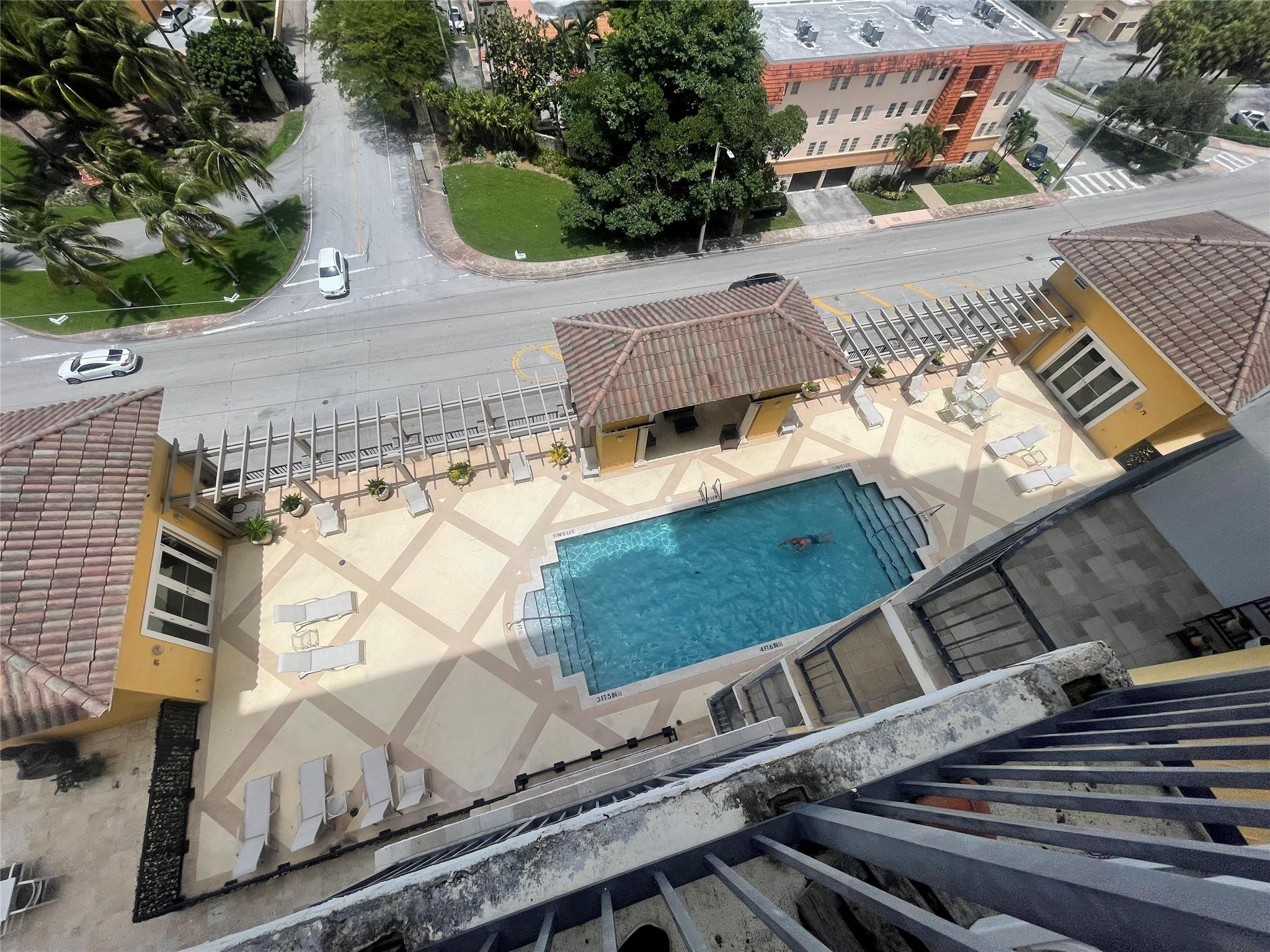 1627 Southwest 37th Avenue, Unit 701 Miami, FL 33145 - Photo 3 of 19 VIEW OF POOL FROM BALCONY