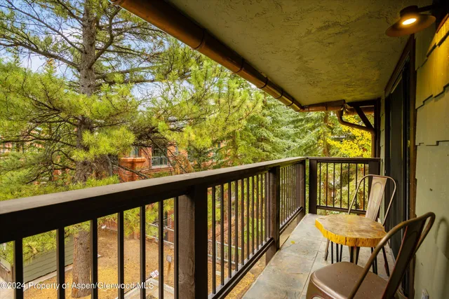 a view of a balcony with furniture