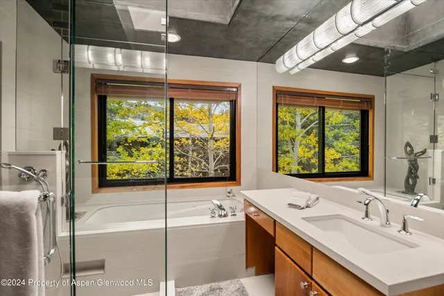 a bathroom with a sink and a large window