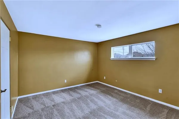 a view of a room with a big yard