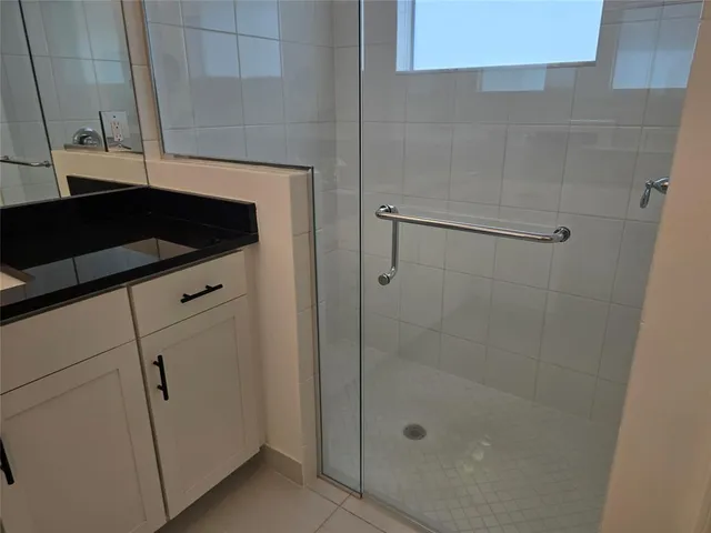 a bathroom with a shower and vanity