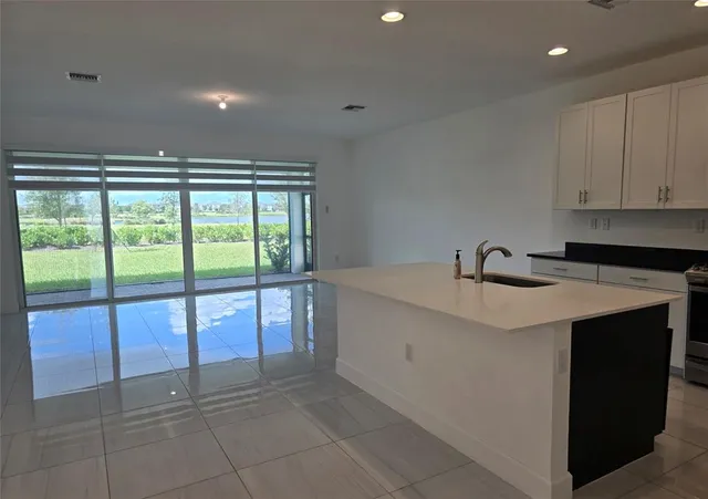 a kitchen with a sink and a large window