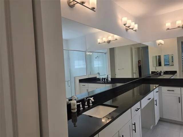 a bathroom with a double vanity sink and a mirror