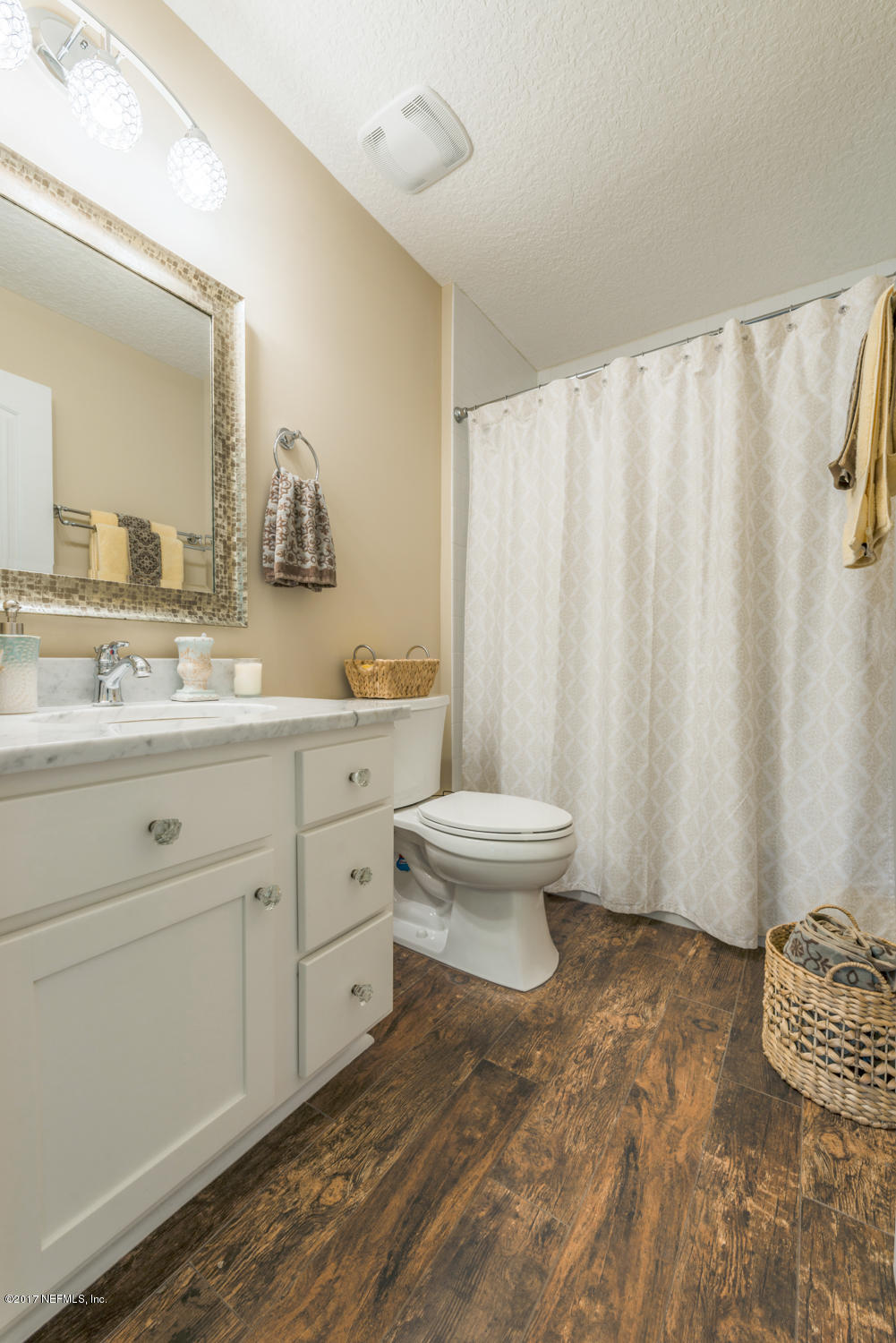 279 Basque Road St. Augustine, FL 32080 - Photo 13 of 29 a bathroom with a toilet sink and mirror