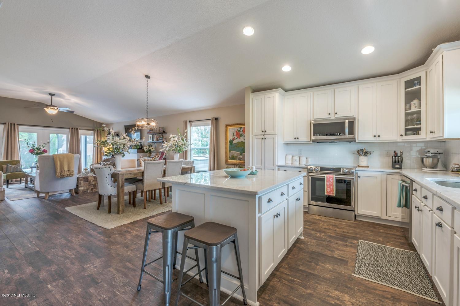 279 Basque Road St. Augustine, FL 32080 - Photo 29 of 29 a kitchen with kitchen island granite countertop a sink and cabinets