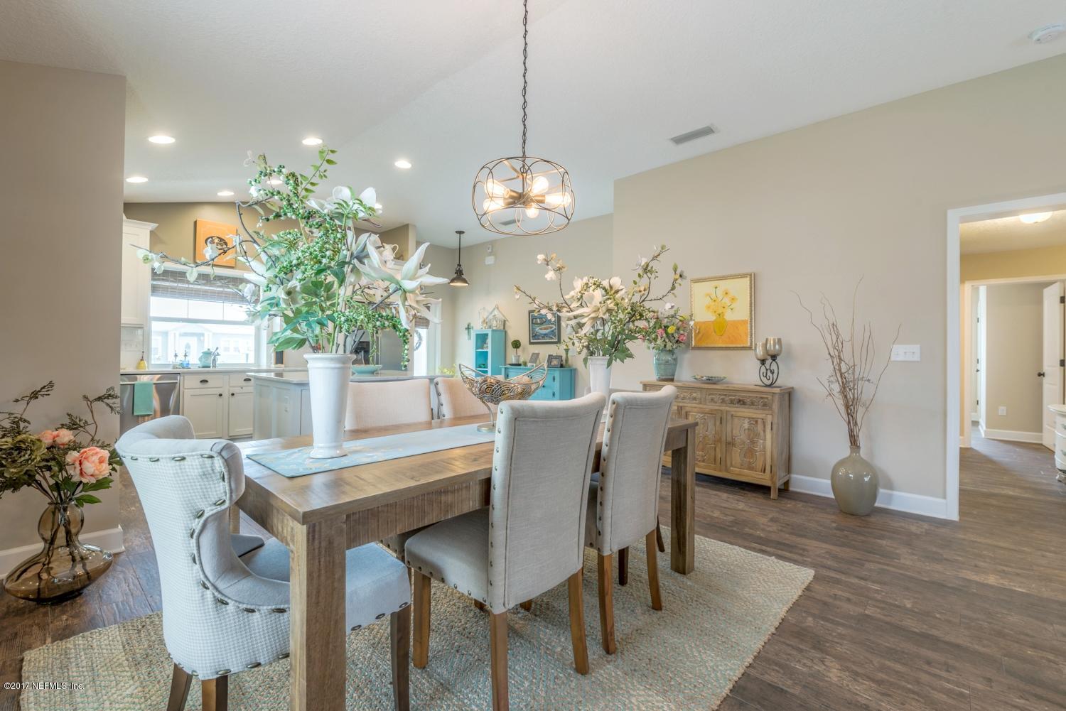 279 Basque Road St. Augustine, FL 32080 - Photo 5 of 29 a dining room with furniture a chandelier and wooden floor
