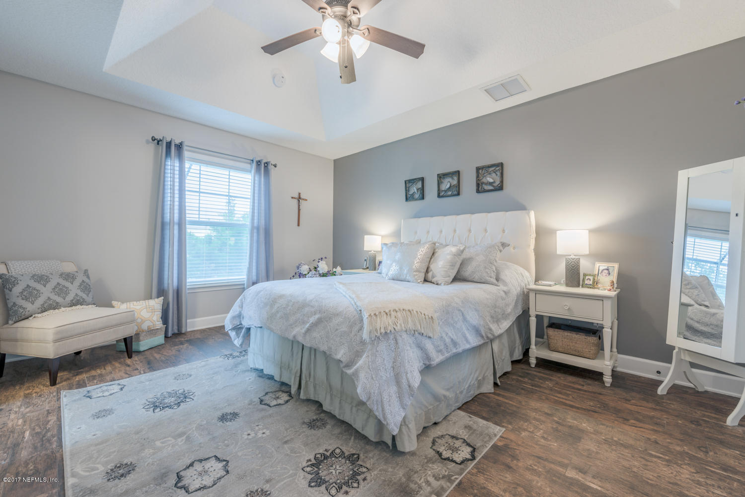279 Basque Road St. Augustine, FL 32080 - Photo 8 of 29 a spacious bedroom with a bed and a chandelier