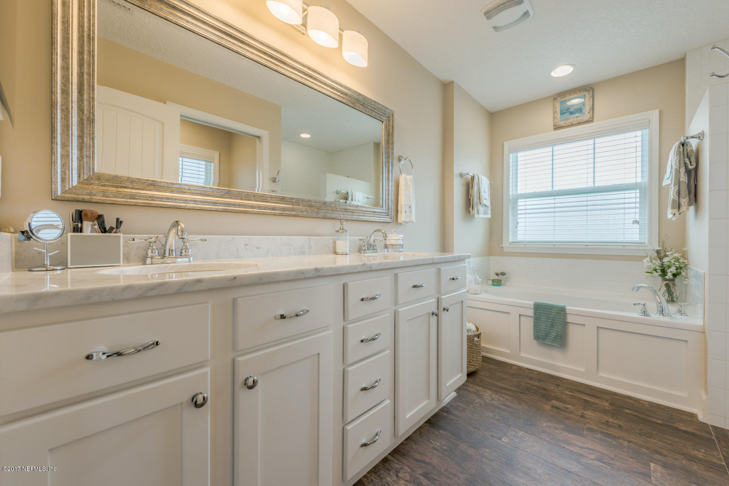 279 Basque Road St. Augustine, FL 32080 - Photo 9 of 29 a bathroom with double vanity sink a mirror and a bathtub