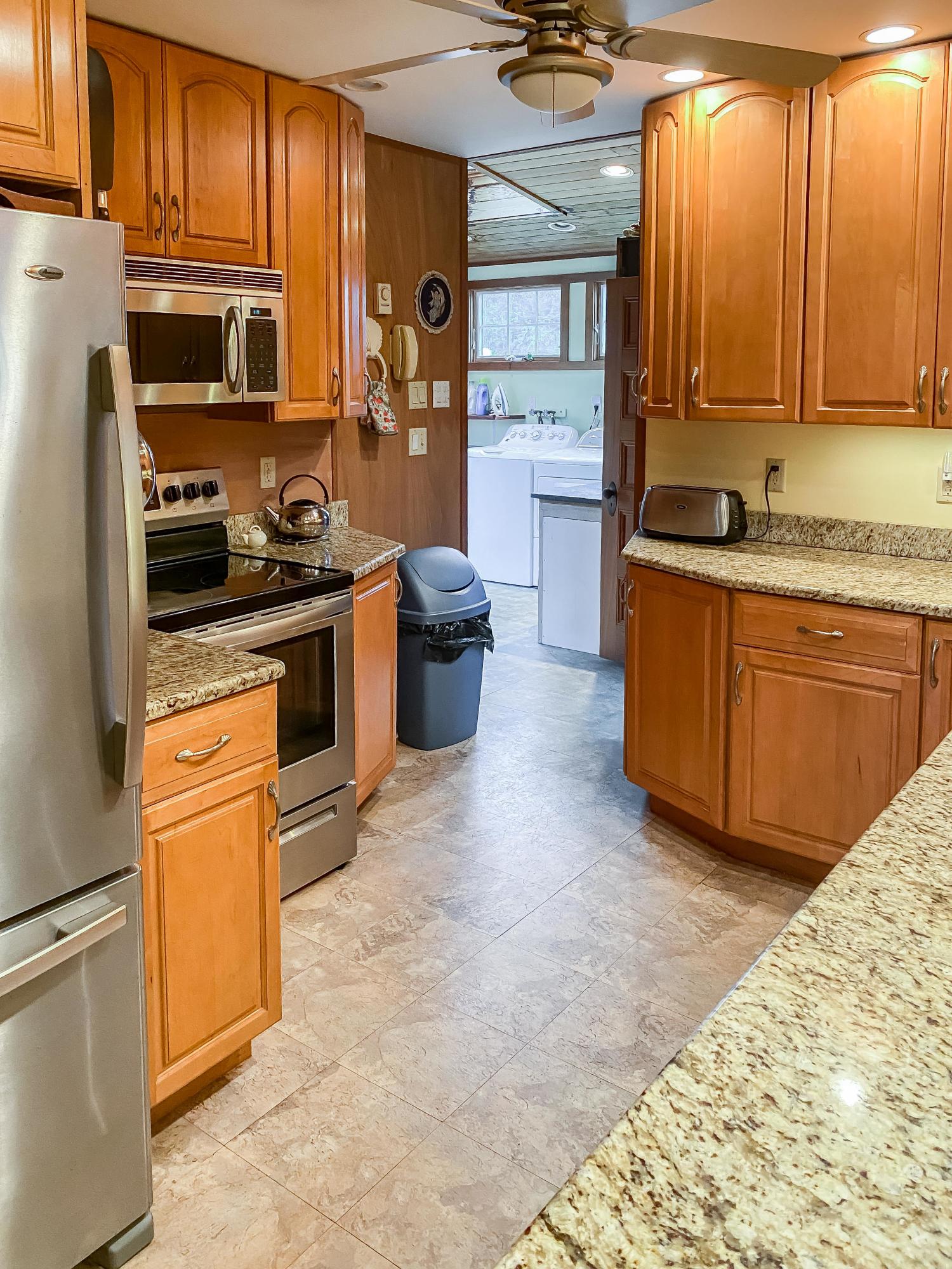 166 Katama Road Edgartown, MA 02539 - Photo 18 of 42 a kitchen with stainless steel appliances granite countertop a stove a sink and a refrigerator