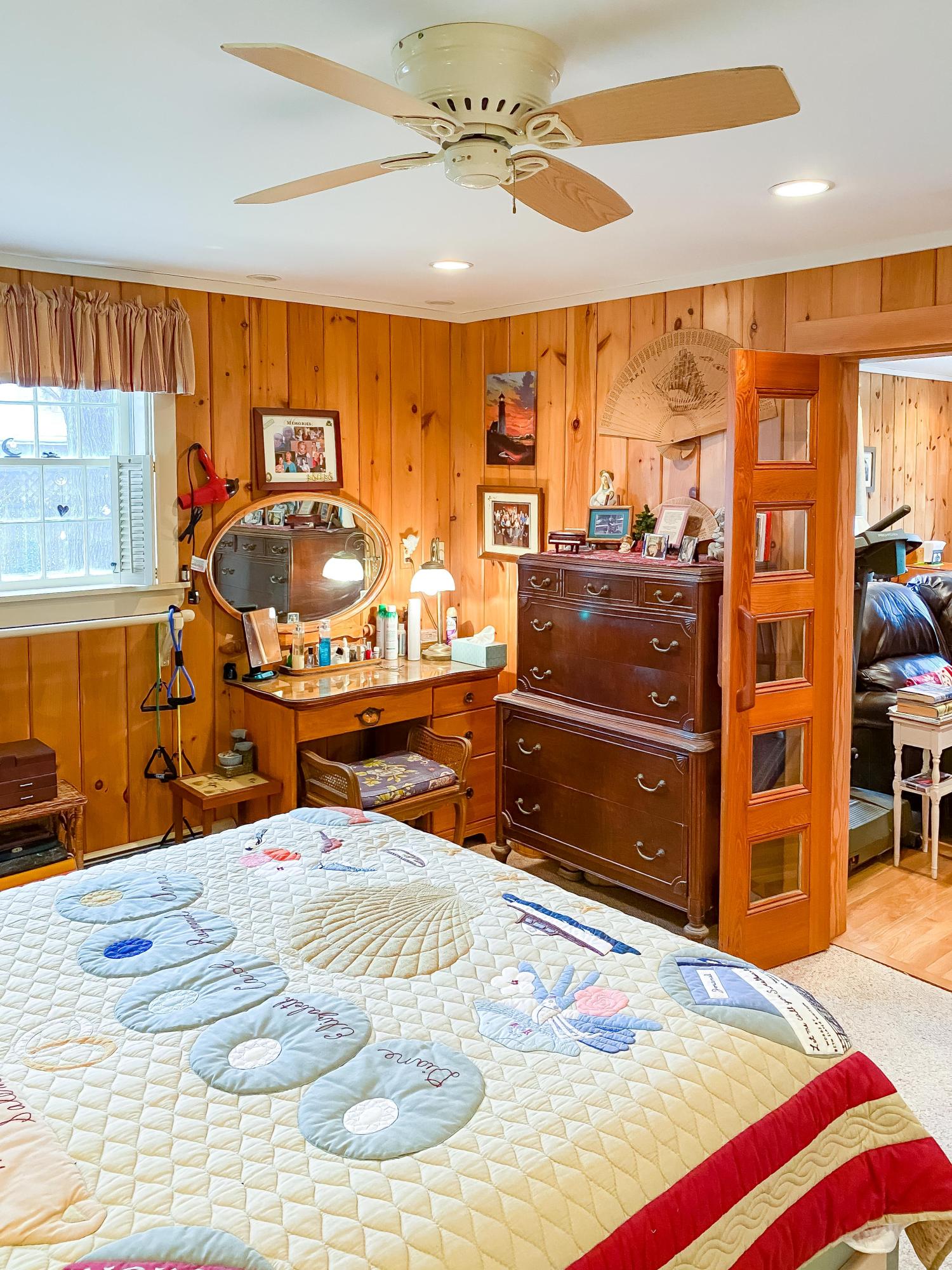 166 Katama Road Edgartown, MA 02539 - Photo 29 of 42 a bedroom with a bed and wooden cabinets