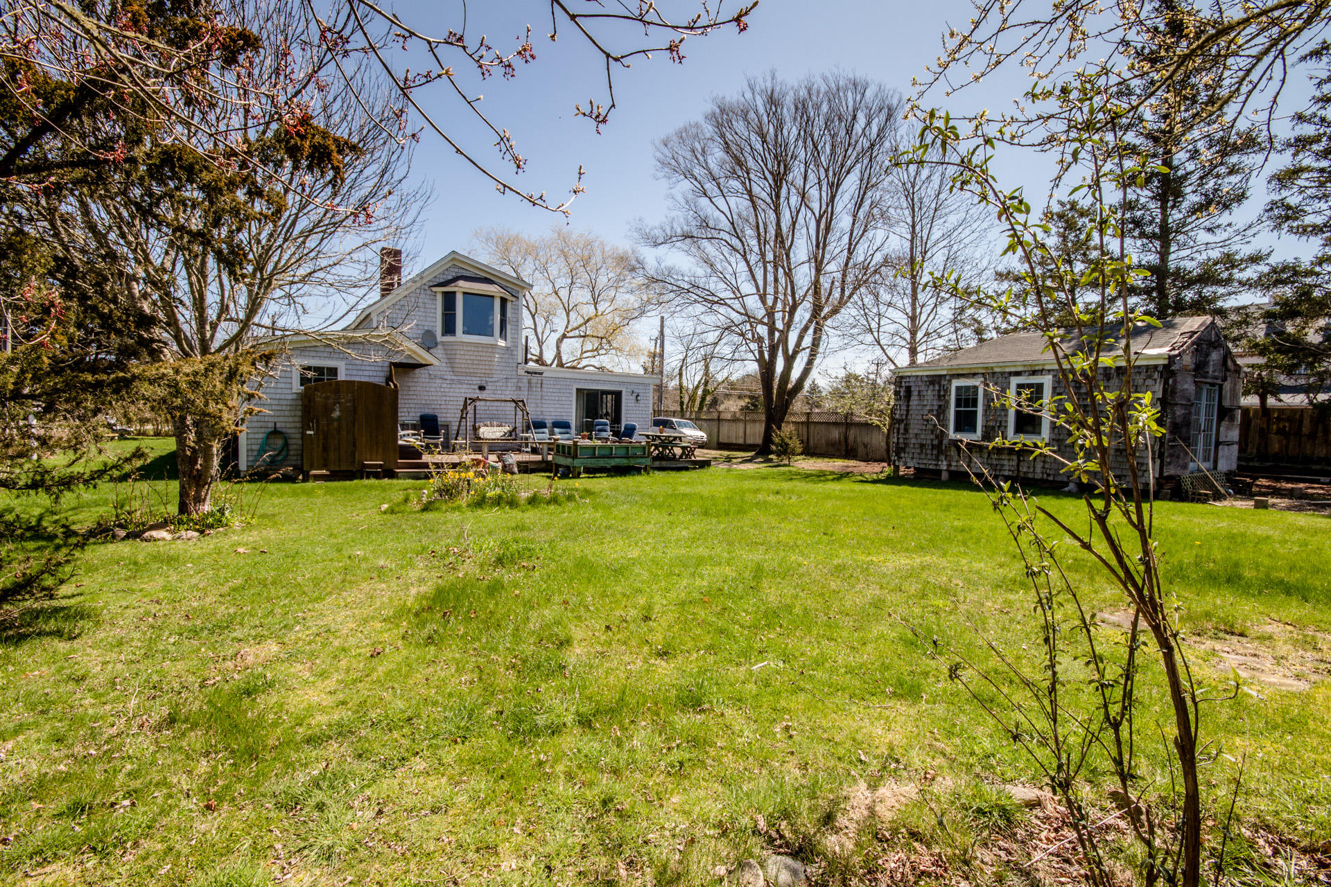 166 Katama Road Edgartown, MA 02539 - Photo 7 of 42 a view of a white house with a large tree